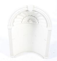 Architectual feature - a plaster alcove. With an arched top, fluted columns and shell moulding.