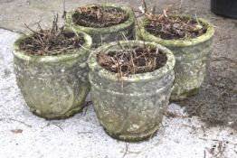 Set of four composite stone garden planters.