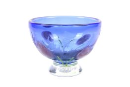 A Caithness blue glass bowl decorated with red flowers and etched with thistles.