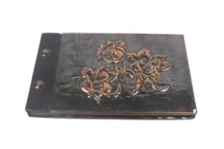 A 20th century copperwork covered photo album.