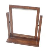 A contemporary swing mirror. The rectangular mirror mounted in a wooden frame.