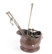 An early 20th century brass and copper fire companion set.