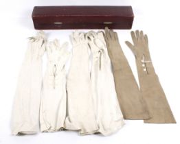 Two pairs of early 20th century lady's calf skin long evening gloves and two odd gloves.