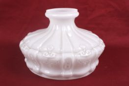 An early 20th century white moulded glass lamp shade. Of circular form with textured decoration.