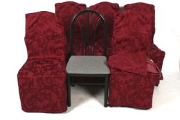 A set of six contemporary moulded dining chairs with covers.