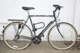 A gents Raleigh Pioneer Deluxe 10 sis bicycle. Comes with pump, lights and a rack.
