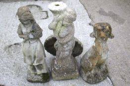Three reconstituted stone garden ornaments. Of a seated dog, a girl holding flowers and a bird bath.