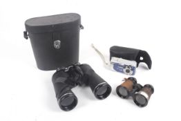 Two pair of binoculars and a Canon camera.
