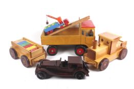 A collection of four vintage wooden toy vehicles.