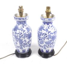 A pair of Chinese style blue and white ceramic table lamps.