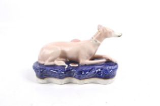 A 20th century Staffordshire pottery inkwell/pen holder modelled as a greyhound.