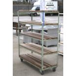 Industrial mobile metal framed shelving unit with wooden slats.