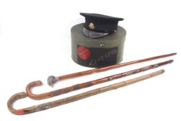 Three walking sticks and a boxed British Red Cross cap.