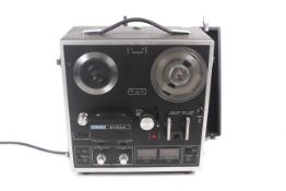 An Akai reel to reel tape recorder.