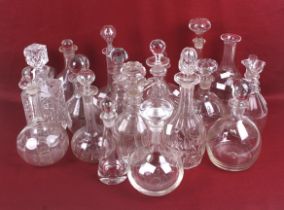 A collection of Victorian and later glass decanters and stoppers.