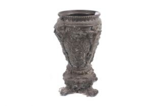 A Victorian heavily decorated metal urn.