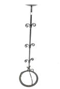 A tall vintage wrought iron candlestick holder.