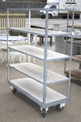 An industrial five tier mobile shelving. With a metal frame and chip board shelves.