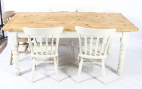 A contemporary pine kitchen table, five chairs and a stool.