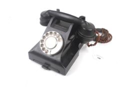 A vintage GPO 332L black Bakelite rotary dial telephone with drawer.