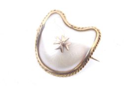 A vintage gold mounted mother of pearl brooch.