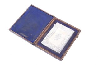 A Victorian silver card case in a fitted leather box.