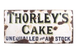 An advertising vitreous enamel sign for 'Thorley's Cake, unequalled for all stock'. 40.5cm x 84.