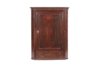 A Georgian mahogany corner cabinet.