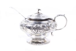 A Victorian silver embossed pear-shaped mustard pot on foot.