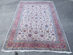 A large cream ground Persian rug, possibly Sarouk.