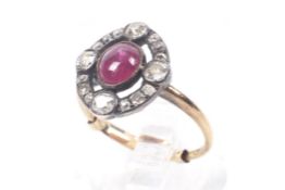 An Edwardian gold, cabochon ruby and old-cut diamond oval cluster ring.