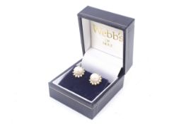 A pair of modern 18ct gold, cultured-pearl and diamond cluster stud earrings. Each centred with a 7.