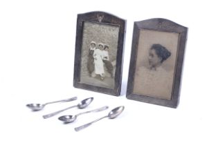 A pair of Art Deco silver mounted oak easel-back rectangular photograph frames.