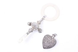 An embossed silver child's rattle/teether and a scent bottle.