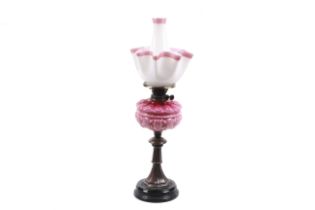 A Victorian Youngs Clissold oil lamp with satin pink reserve.