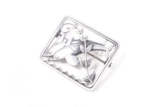 Georg Jensen, a sterling rectangular openwork brooch depicting two dolphins and a seaweed frond.