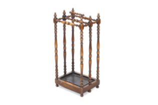 An Edwardian mahogany stick stand. WIth elaborately turned finials and supports. H66cm.