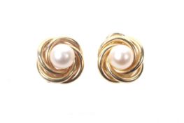 A pair of vintage Italian gold and cultured-pearl knot earrings. Each centred with a 7.