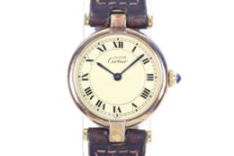 Must de Cartier, a lady's silver gilt round wrist watch.