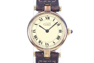 Must de Cartier, a lady's silver gilt round wrist watch.