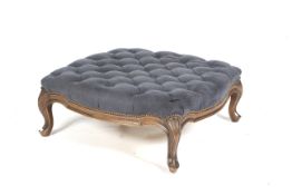 A Louis XV style stained beech button back large low upholstered foot stool.