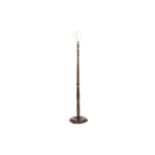 A 1930s/40s mahogany standard lamp with turned column on a round stepped base. H151cm.