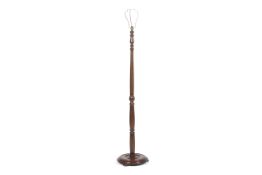 A 1930s/40s mahogany standard lamp with turned column on a round stepped base. H151cm.