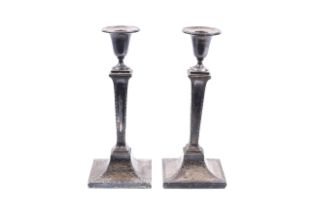 A pair of Edwardian silver candlesticks.