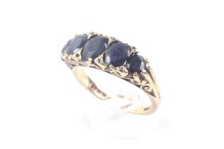 A vintage 18ct gold and sapphire five stone carved half-hoop ring with rose diamond points.