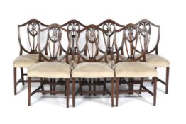 A 20th century mahogany set of seven shield back chairs.