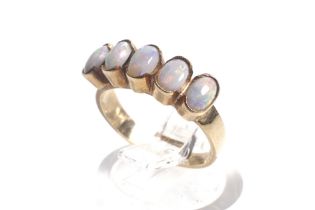 A vintage gold and opal five stone ring.