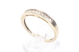 A modern 9ct gold and small diamond half-eternity ring. The ten round brilliants approx. 0.