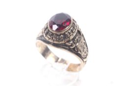 A vintage Canadian gold and synthetic-ruby high school graduation ring,