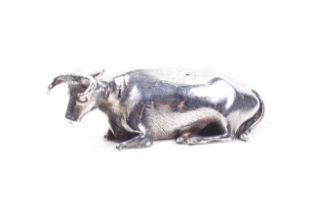 A William IV silver butter dish finial in the form of a recumbent cow.